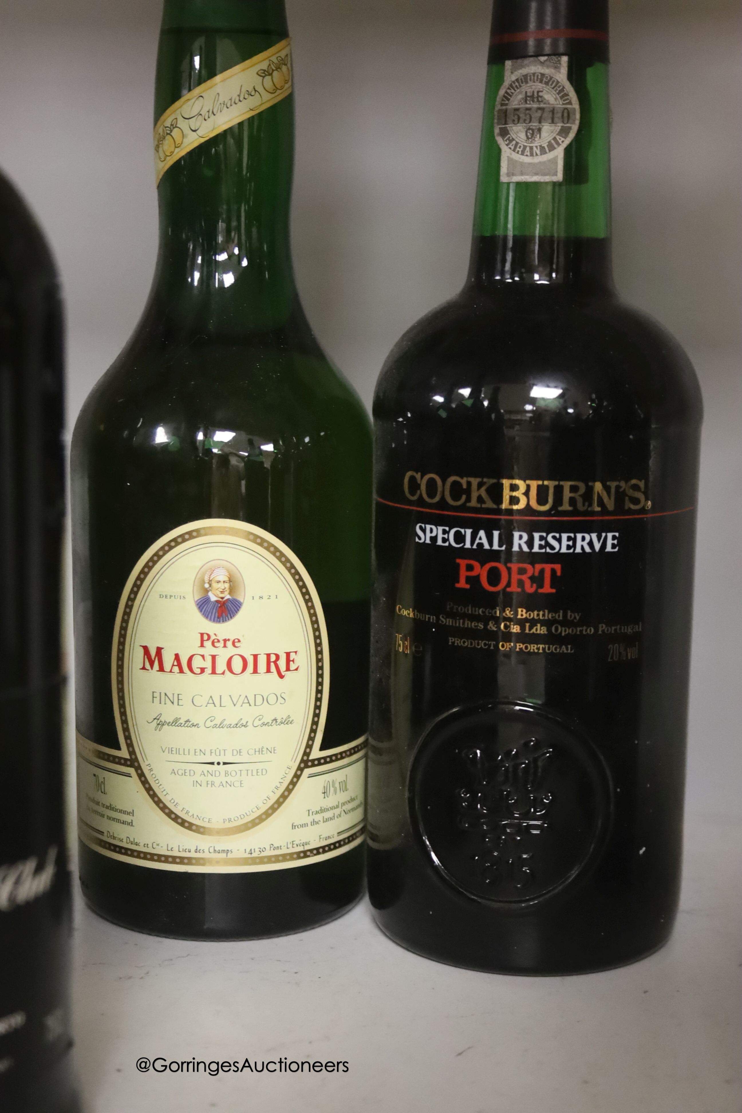 Thirteen assorted bottles of Port including Dow's 1975 and 1977 and one bottle of Magloire Calvados
